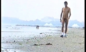 amatorial young boy strolling naked on an obstacle littoral